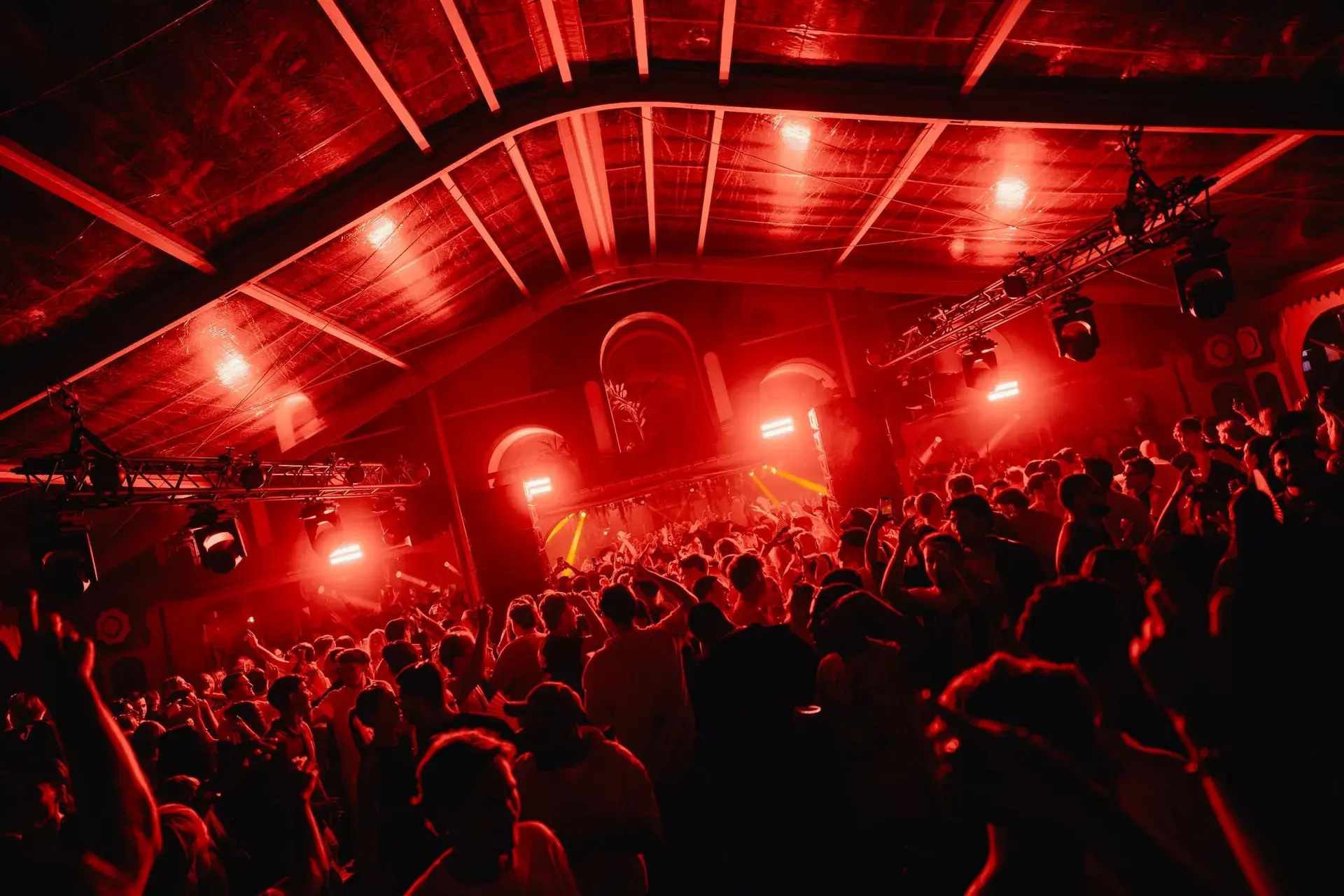 Colorado Charlie’s dance floor filled with fans beneath red stage lighting