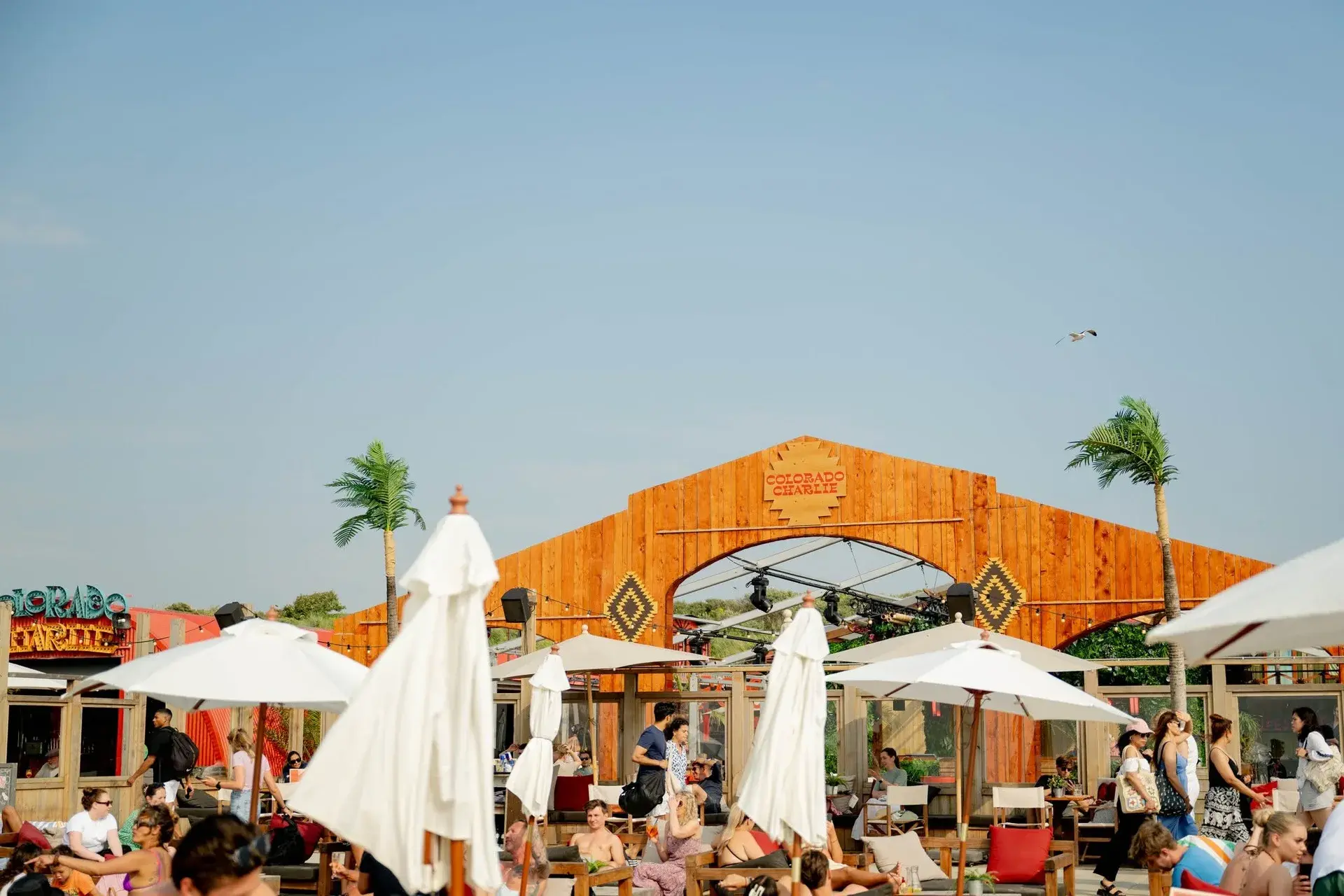 Colorado Charlie’s beach club and terrace beneath a blue sky